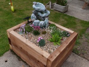 Raised water feature and alpine bed